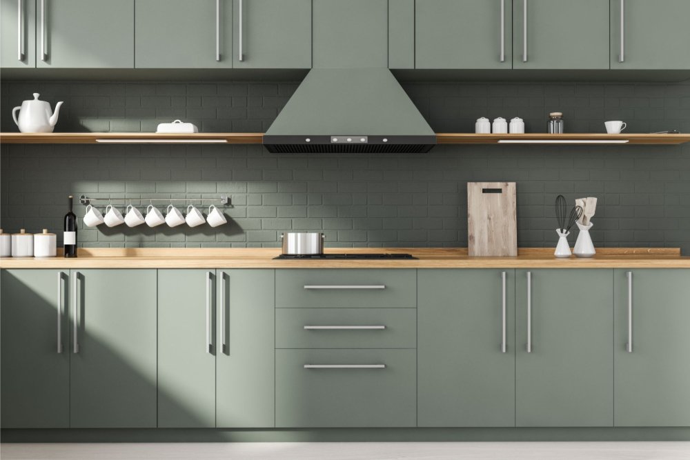 Sage green matte painted cabinets in a stylish kitchen
