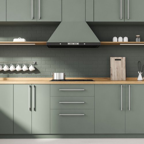 Sage green matte painted cabinets in a stylish kitchen