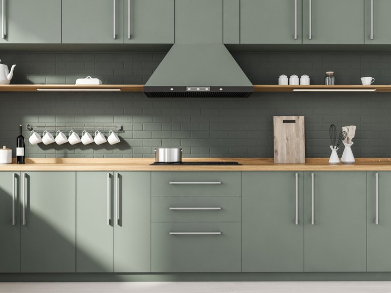 Sage green matte painted cabinets in a stylish kitchen
