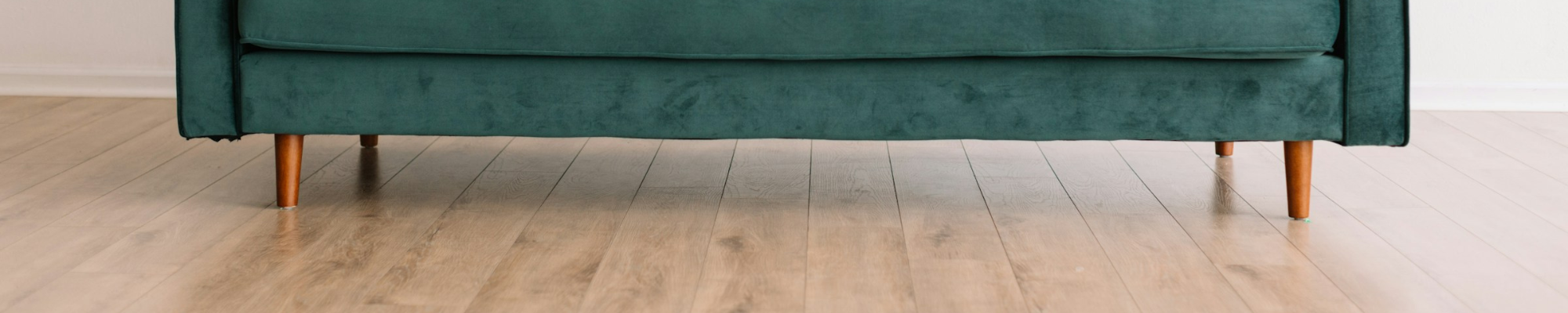 Luxury Vinyl floor with a green velvet sofa